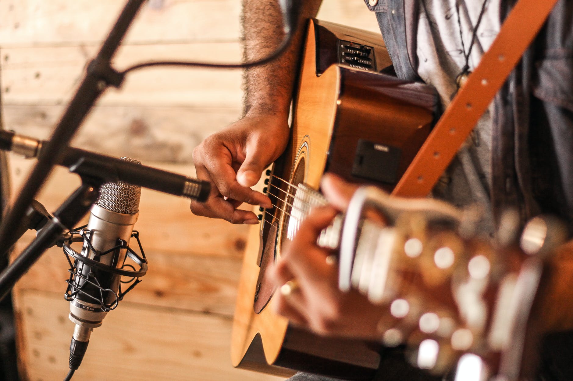 person playing acoustic guitar